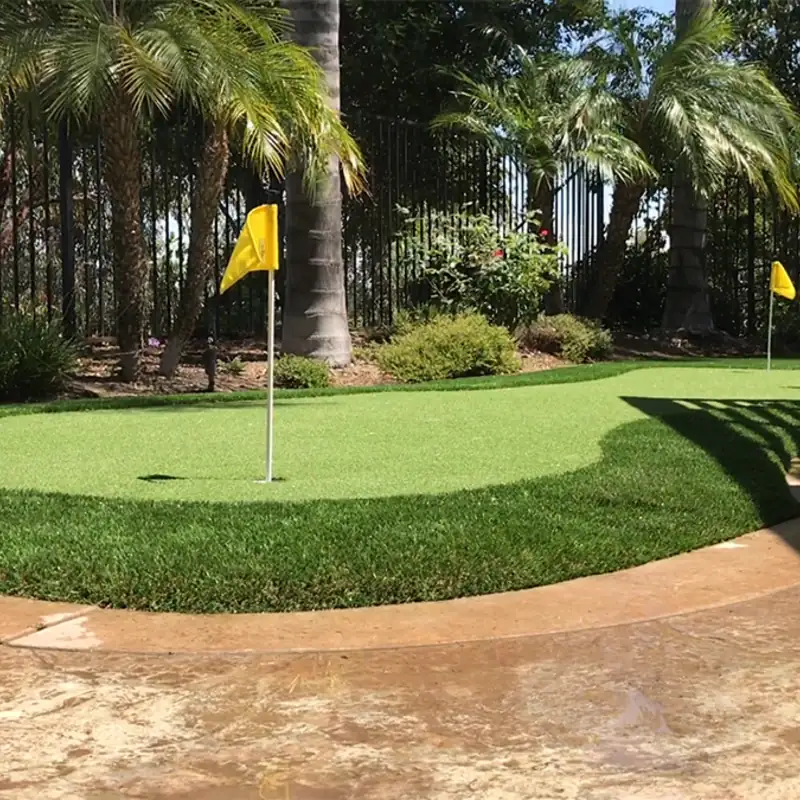 Backyard artificial turf putting green with practice flags